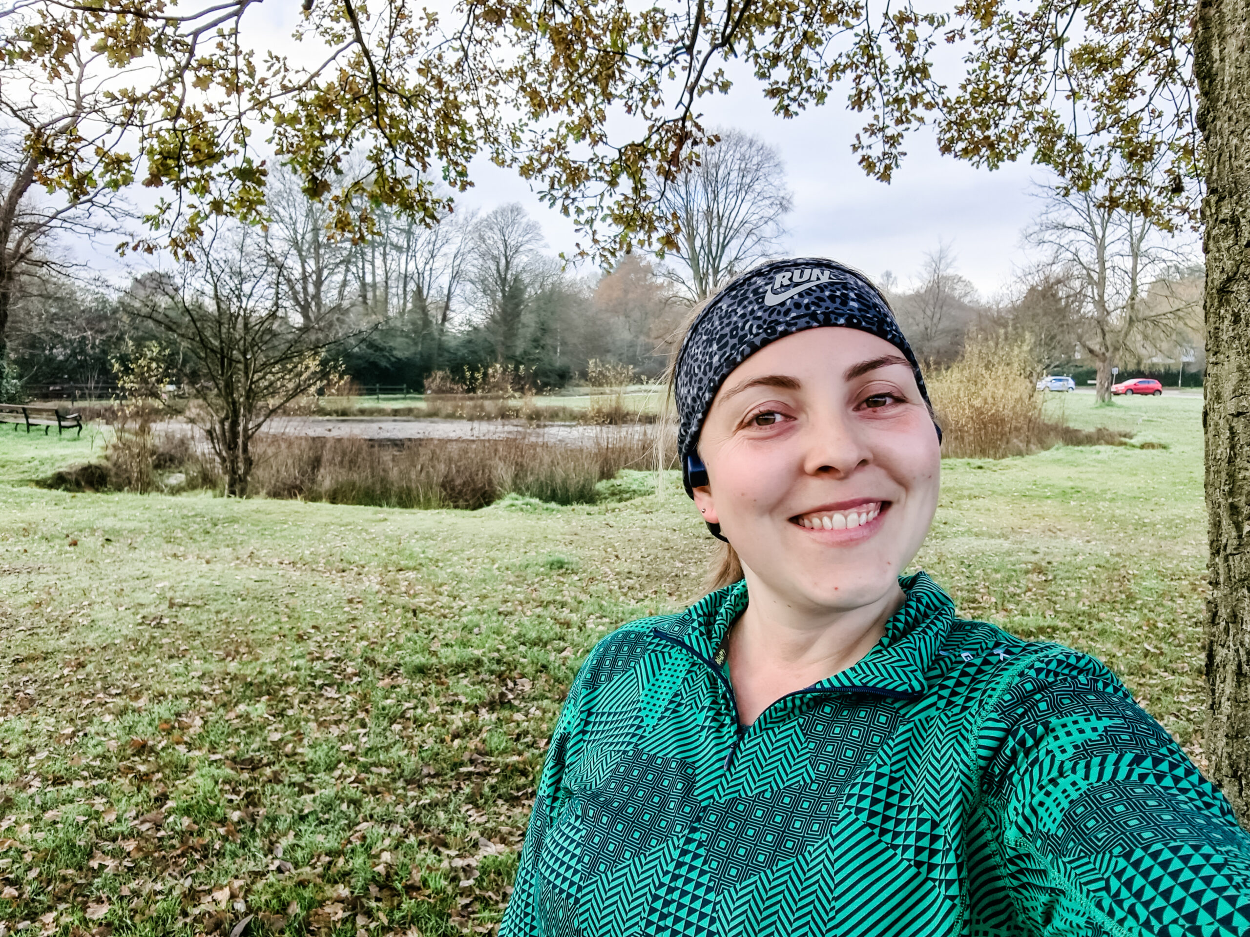 Running selfie in front of green and pond