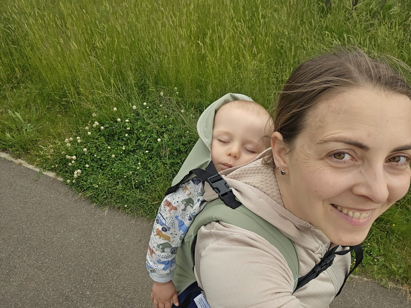woman carrying sleeping baby on her back