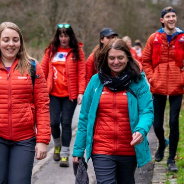 GetOutside Champions in orange jackets walking along the road