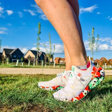Photo of legs wearing white and flowery patterned running shoes